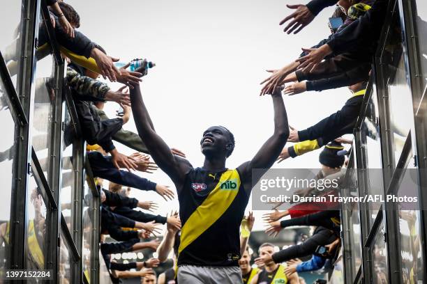 Bigoa Nyuon off the Tigers acknowledges the fans during the round nine AFL match between the Hawthorn Hawks and the Richmond Tigers at Melbourne...