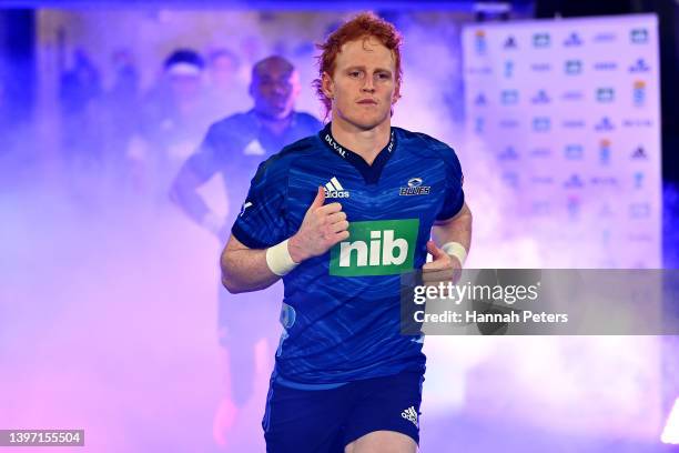 Finlay Christie of the Blues runs onto the field during the round 13 Super Rugby Pacific match between the Blues and the Queensland Reds at Eden Park...
