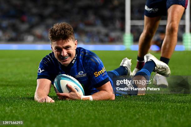 Beauden Barrett of the Blues scores a try during the round 13 Super Rugby Pacific match between the Blues and the Queensland Reds at Eden Park on May...