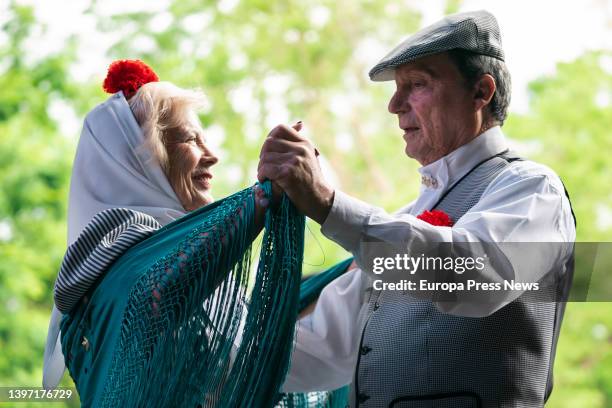 Couple, dressed as chulapa and chulapo, dance a chotis, in an act of the Federacion Grupos Tradicionales madrileños during the San Isidro...