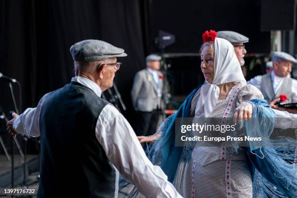 Couple, dressed as chulapa and chulapo, dance a chotis, in an act of the Federacion Grupos Tradicionales madrileños during the San Isidro...