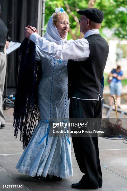 Couple, dressed as chulapa and chulapo, dance a chotis, in an act of the Federacion Grupos Tradicionales madrileños during the San Isidro...