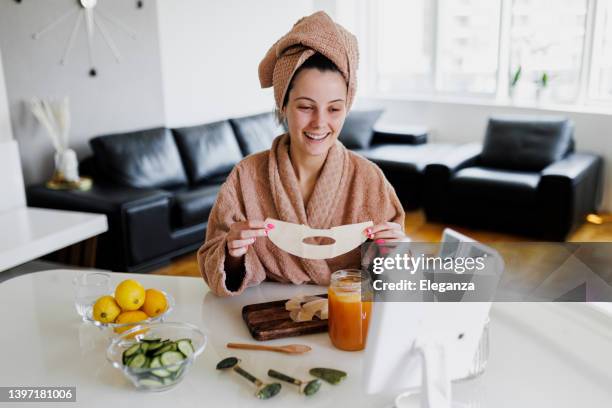 young woman applying face mask at home. natural skin care routine for glowing skin. woman at home having skin care routine. concept of natural cosmetics skin care - honey face mask stock pictures, royalty-free photos & images