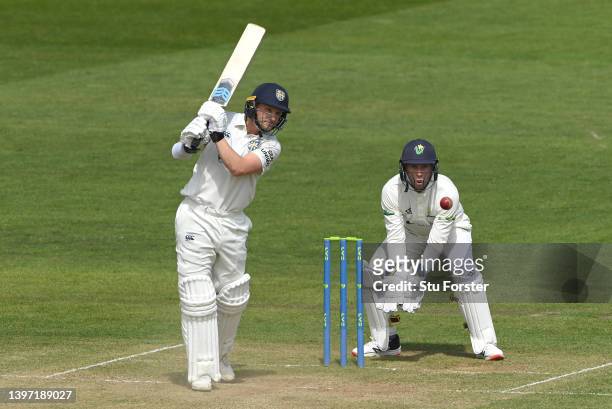 Durham batsman Scott Borthwick drives a ball for runs watched by wicketkeeper Chris Cooke during the LV= Insurance County Championship match between...