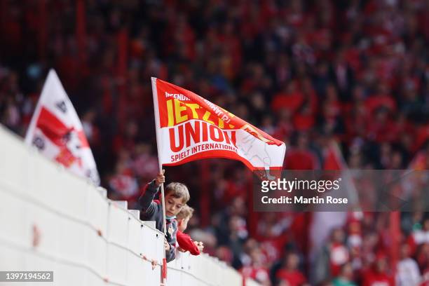 Union Berlin fan holds a flag inside the stadium prior to the Bundesliga match between 1. FC Union Berlin and VfL Bochum at Stadion An der Alten...