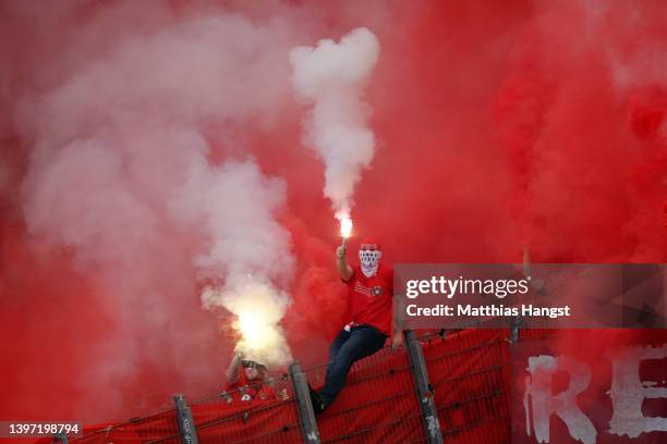 Koeln fans wave flares prior to the Bundesliga match between VfB Stuttgart and 1. FC Köln at Mercedes-Benz Arena on May 14, 2022 in Stuttgart,...