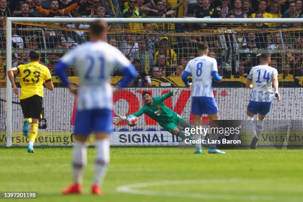 Roman Buerki of Borussia Dortmund fails to save the Hertha BSC first goal scored by Ishak Belfodil from the penalty spot during the Bundesliga match...