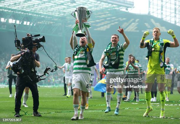 Callum McGregor of Celtic lifts The Cinch Premiership trophy after their sides victory during the Cinch Scottish Premiership match between Celtic and...