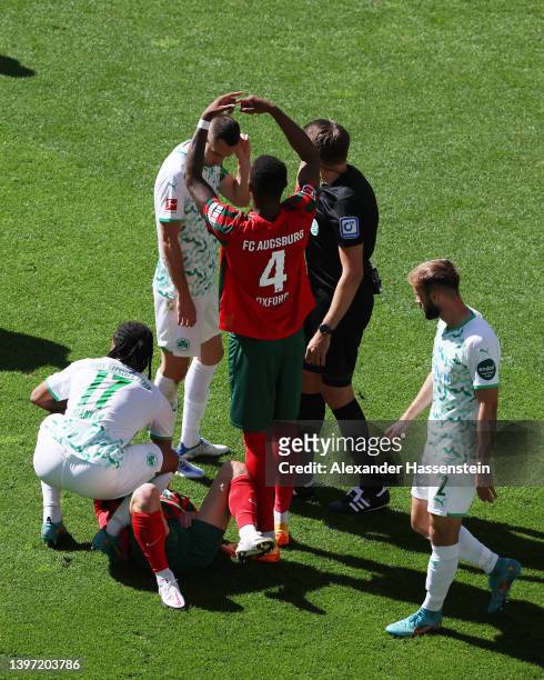 Niklas Dorsch of FC Augsburg receives medical treatment during the Bundesliga match between FC Augsburg and SpVgg Greuther Fürth at WWK-Arena on May...