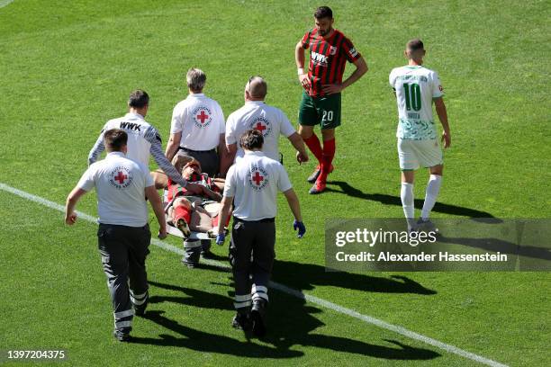 Niklas Dorsch of FC Augsburg is stretchered off the pitch after an injury during the Bundesliga match between FC Augsburg and SpVgg Greuther Fürth at...