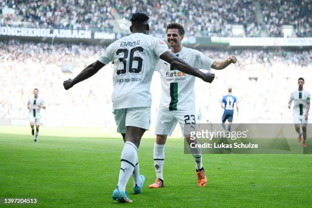 Jonas Hofmann of Borussia Monchengladbach celebrates with teammate Breel Embolo after scoring their side's third goal during the Bundesliga match...
