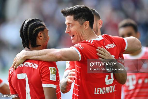 Robert Lewandowski celebrates with Serge Gnabry of FC Bayern Muenchen after scoring their team's second goal during the Bundesliga match between VfL...