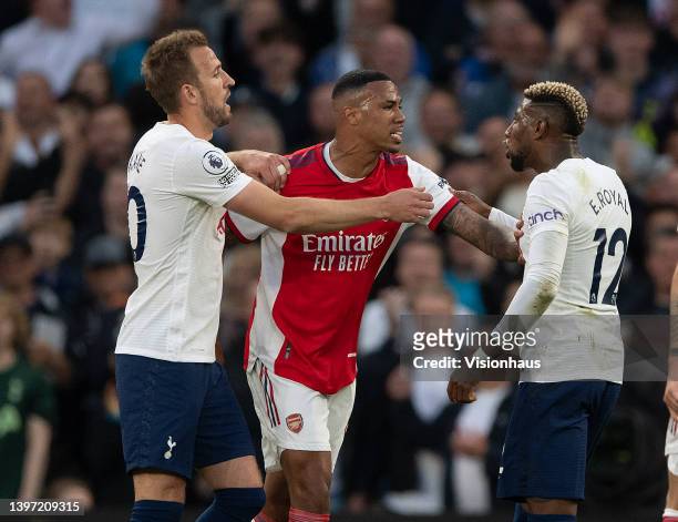Harry Kane of Tottenham Hotspur holds back Gabriel of Arsenal from Emerson Royal of Tottenham during the Premier League match between Tottenham...
