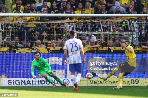 Erling Haaland of Borussia Dortmund scores their side's first goal from the penalty spot past Marcel Laurenz Lotka of Hertha BSC during the...