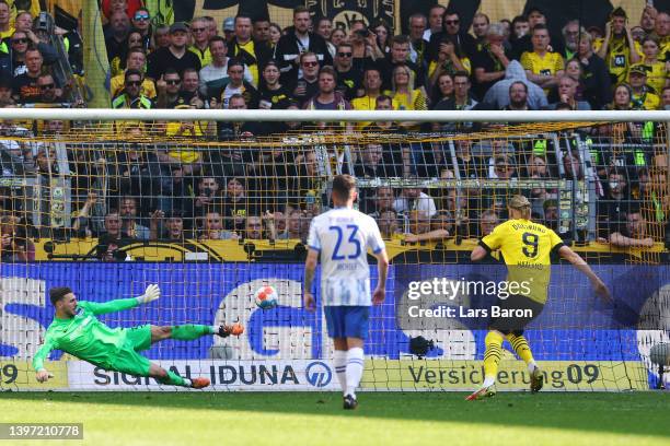 Erling Haaland of Borussia Dortmund scores their side's first goal from the penalty spot past Marcel Laurenz Lotka of Hertha BSC during the...