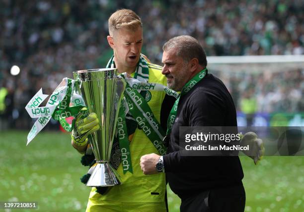 Celtic manager Ange Postecoglou and Joe Hart are with the Cinch Scottish premiership trophy seen during the Cinch Scottish Premiership match between...