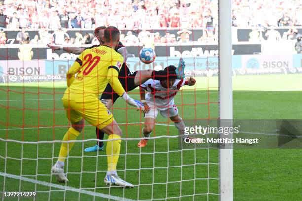 Wataru Endo of VfB Stuttgart scores their team's second goal past Marvin Schwaebe of 1.FC Koeln during the Bundesliga match between VfB Stuttgart and...