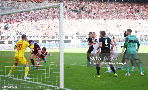 Wataru Endo of VfB Stuttgart scores their team's second goal past Marvin Schwaebe of 1.FC Koeln during the Bundesliga match between VfB Stuttgart and...