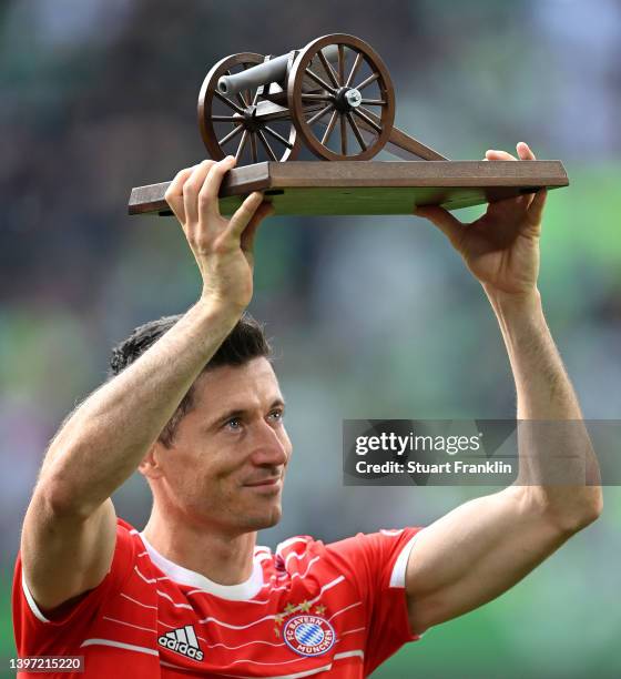 Robert Lewandowski of FC Bayern Muenchen receives the Bundesliga Top Scorer trophy after finishing the season with the most goals scored in the...