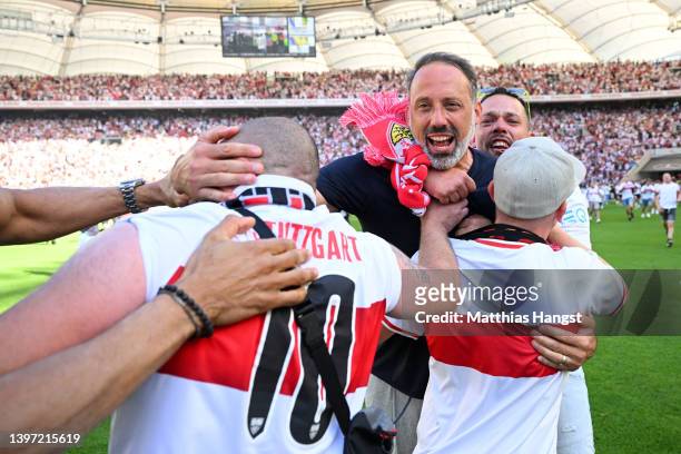 Pellegrino Matarazzo, Head Coach of VfB Stuttgart celebrates with the fans on the pitch after their side avoided the relegation play offs after their...