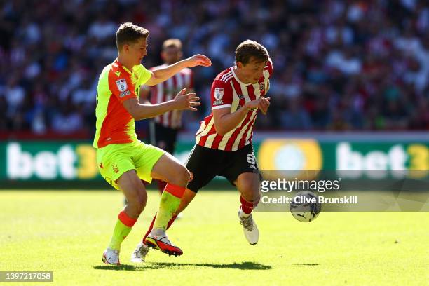 Sander Berge of Sheffield United is challenged by Ryan Yates of Nottingham Forest during the Sky Bet Championship Play-Off Semi Final 1st Leg match...