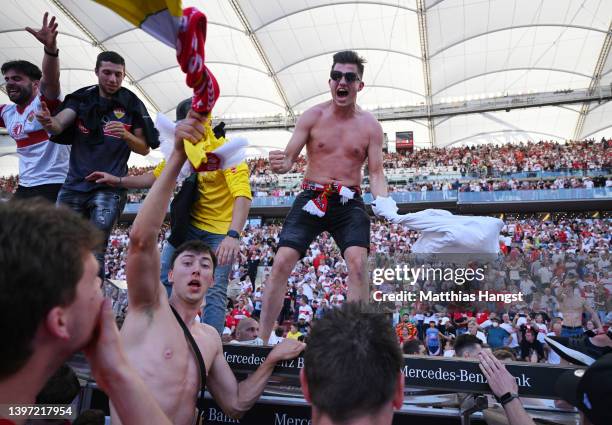 VfB Stuttgart fans celebrate on the pitch after their side avoided relegation play offs after their sides victory during the Bundesliga match between...