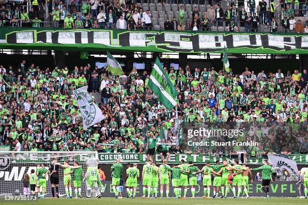 VfL Wolfsburg players embrace the fans after their sides draw during the Bundesliga match between VfL Wolfsburg and FC Bayern München at Volkswagen...