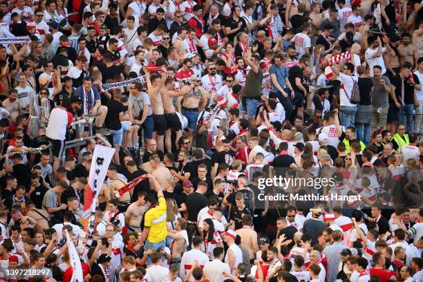 VfB Stuttgart fans celebrate on the pitch after their side avoided relegation play offs after their sides victory during the Bundesliga match between...