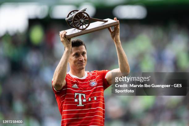 Robert Lewandowski of FC Bayern Muenchen receives the Bundesliga Top Scorer trophy after finishing the season with the most goals scored in the...