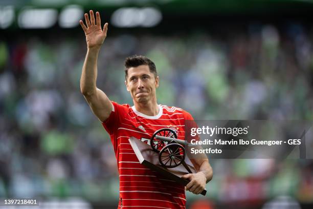 Robert Lewandowski of FC Bayern Muenchen receives the Bundesliga Top Scorer trophy after finishing the season with the most goals scored in the...