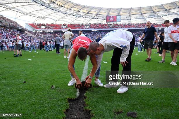 Part of the pitch is removed by VfB Stuttgart players after their sides victory, which resulted in their side avoiding the relegation play offs...