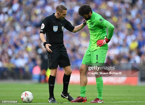 Referee Craig Pawson speaks to Alisson Becker of Liverpool during The FA Cup Final match between Chelsea and Liverpool at Wembley Stadium on May 14,...