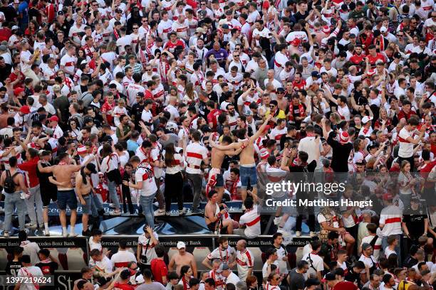 VfB Stuttgart fans celebrate on the pitch after their side avoided relegation play offs after their sides victory during the Bundesliga match between...