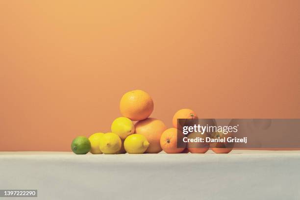 a pile of citrus fruits - lemon fruit stock pictures, royalty-free photos & images