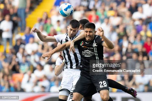 Ignacio Pussetto of Udinese Calcio competes for the ball with Martin Erlic of Spezia Calcio during the Serie A match between Udinese Calcio and...