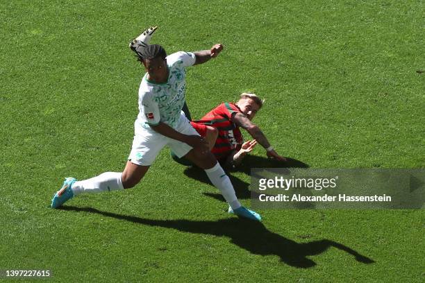 Niklas Dorsch of FC Augsburg gets injured during the Bundesliga match between FC Augsburg and SpVgg Greuther Fürth at WWK-Arena on May 14, 2022 in...