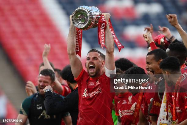 Jordan Henderson of Liverpool lifts The Emirates FA Cup trophy after their sides victory during The FA Cup Final match between Chelsea and Liverpool...