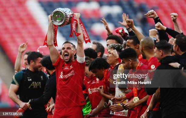 Jordan Henderson of Liverpool lifts The Emirates FA Cup trophy after their sides victory during The FA Cup Final match between Chelsea and Liverpool...