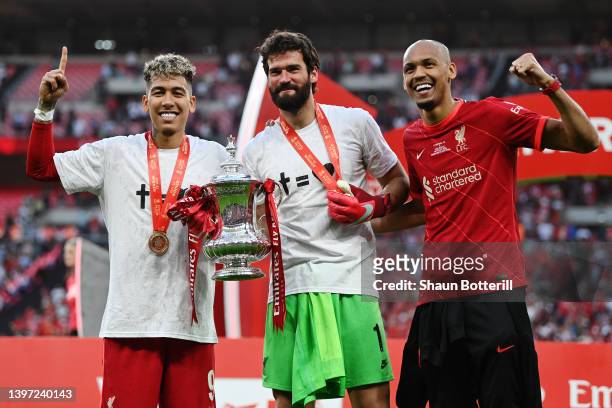 Roberto Firmino, Alisson Becker and Fabinho of Liverpool celebrate with The Emirates FA Cup trophy after their sides victory during The FA Cup Final...