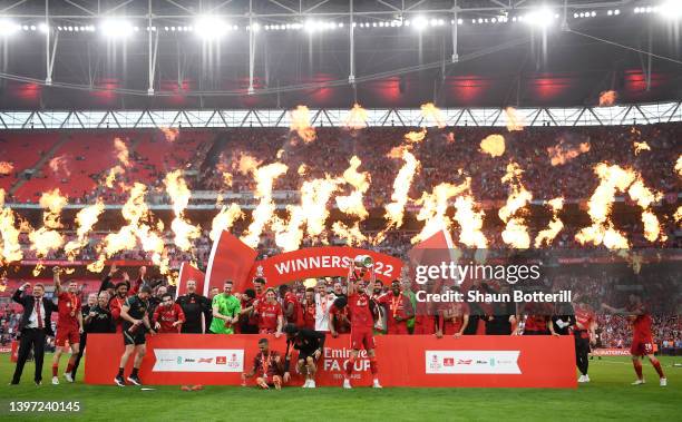 Jordan Henderson of Liverpool lifts The Emirates FA Cup trophy after their sides victory during The FA Cup Final match between Chelsea and Liverpool...