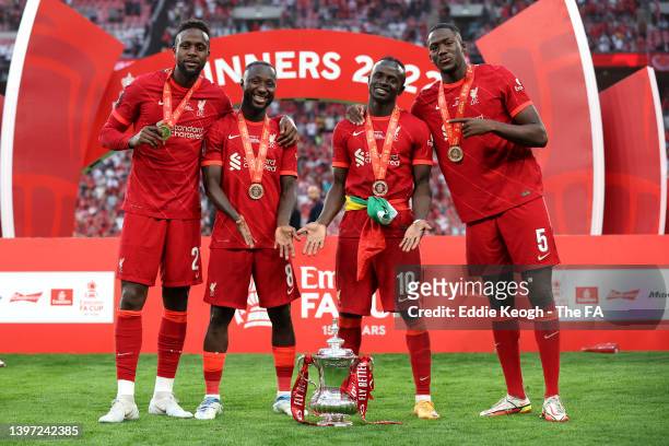 Divock Origi, Naby Keita, Sadio Mane and Ibrahima Konate of Liverpool celebrate with The Emirates FA Cup trophy after their sides victory during The...