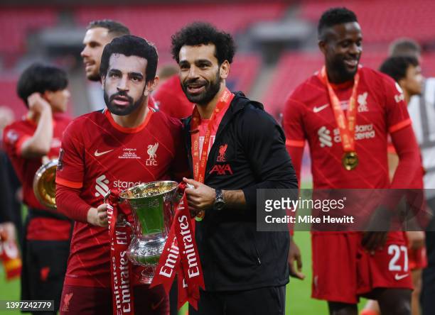 Harvey Elliott and Mohamed Salah of Liverpool celebrate with The Emirates FA Cup trophy after their sides victory during The FA Cup Final match...