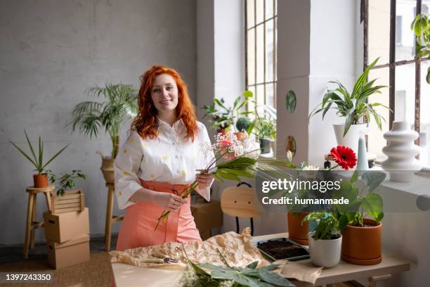 redhead female florist working with flowers - florist bildbanksfoton och bilder