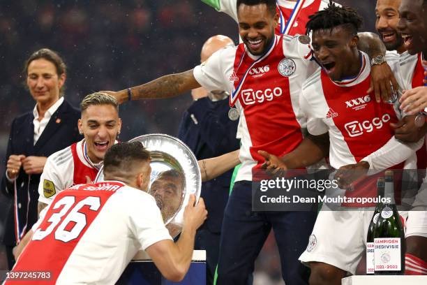 Dusan Tadic of Ajax celebrates their side's victory of the Dutch Eredivisie with the trophy after the Dutch Eredivisie match between Ajax and sc...