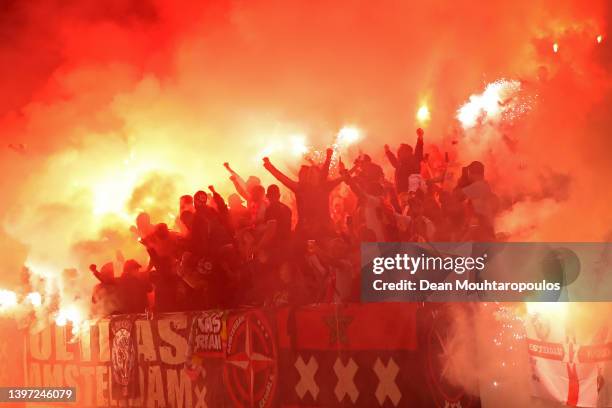 Fans of AFC Ajax show their support and light flares during the Dutch Eredivisie match between Ajax and sc Heerenveen at Johan Cruijff Arena on May...