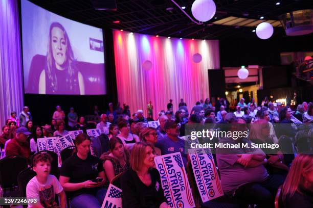 People watch as Jenna Ellis, former Legal Advisor and Counsel to former President Donald Trump, speaks through video during a campaign rally at The...