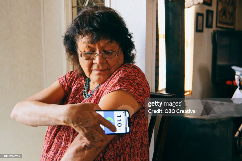 Senior Woman Checking Blood Glucose Level on an App