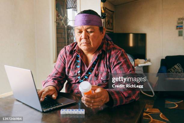 mature man filling medicine prescription online - indios imagens e fotografias de stock