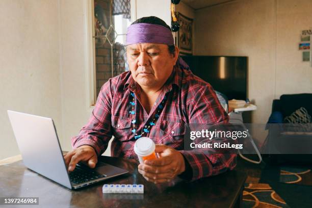 mature man filling medicine prescription online - indian bildbanksfoton och bilder