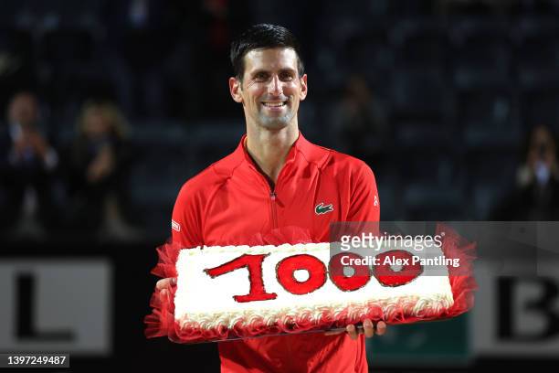 Novak Djokovic of Serbia is presented with a cake after his 1000th career win followng victory in the men's singles semi-final match against Casper...